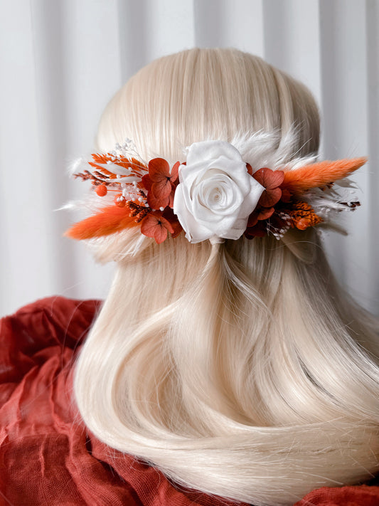 White and burnt orange preserved flower bridal hair comb with white rose and dried flowers for a wedding hairstyle