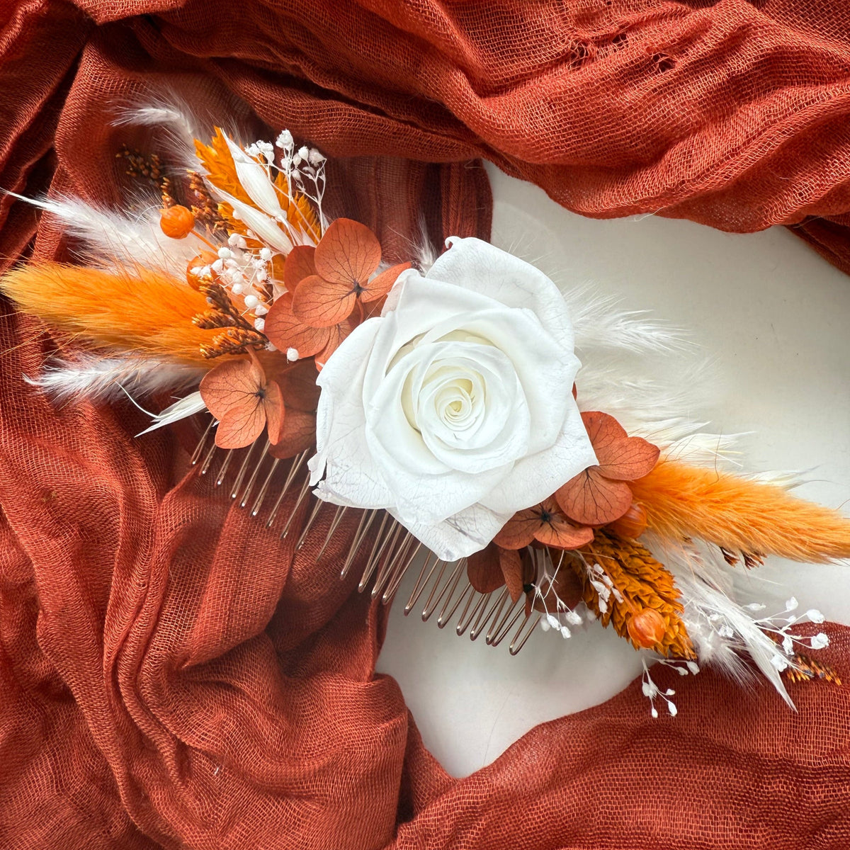 White rose bridal hair comb with burnt orange preserved hydrangea and dried flowers for a romantic wedding hairstyle