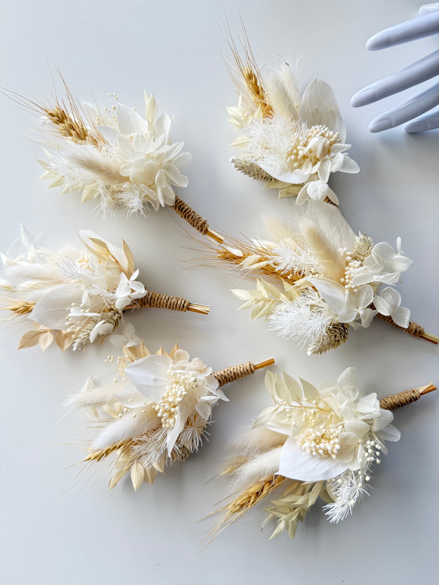 Set of dried flower groom boutoniere on a white background