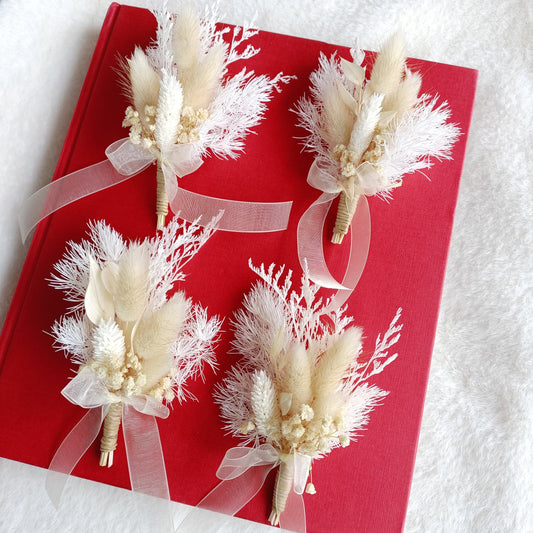 Neutral wedding buttonhole with preserved flowers and soft textures for boho or rustic groom